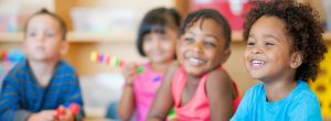 child smiling in a classroom