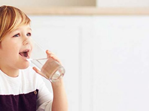 Child drinking a glass of water