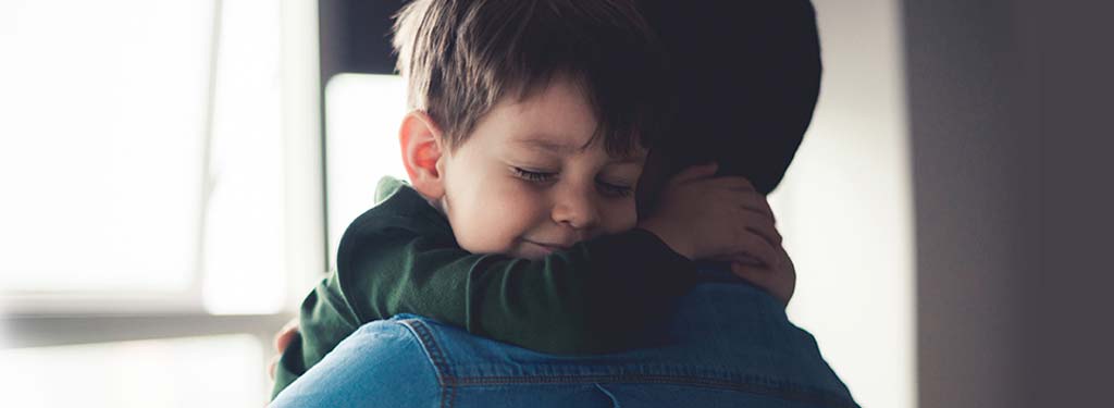 Child cudding his father